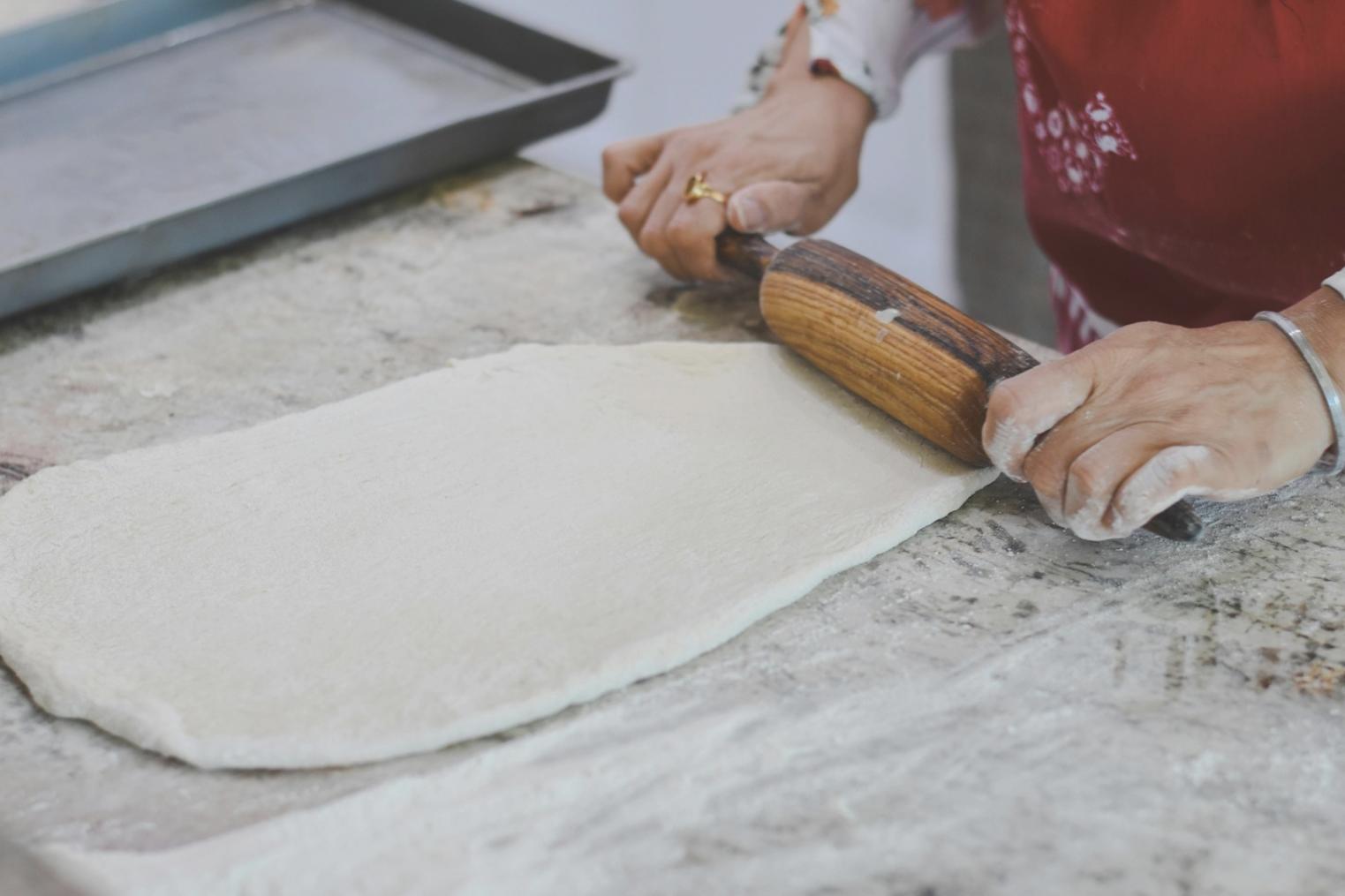 Close-up of hands chopping fresh herbs with a sharp chef's knife