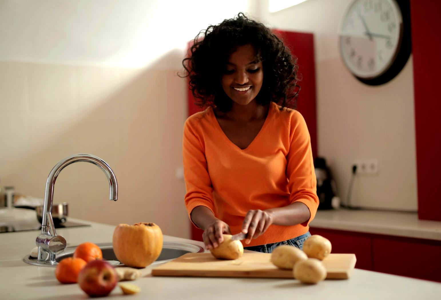 Team member teaching essential knife skills in modern kitchen workshop